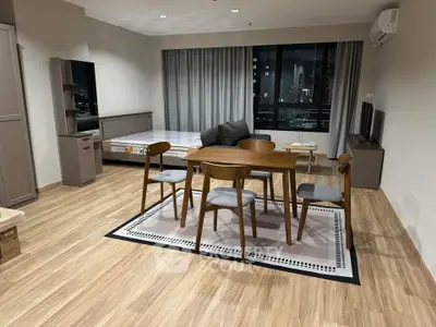 Spacious modern living room with dining area and large window view.
