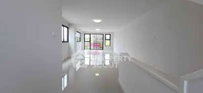 Spacious modern living room with large windows and glossy floors