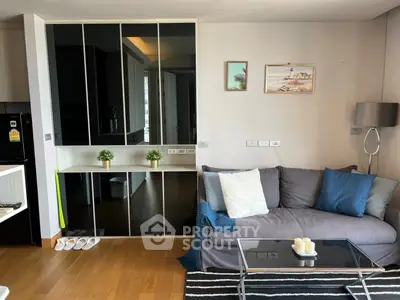 Modern living room with stylish decor, cozy sofa, and elegant glass coffee table in a chic apartment.