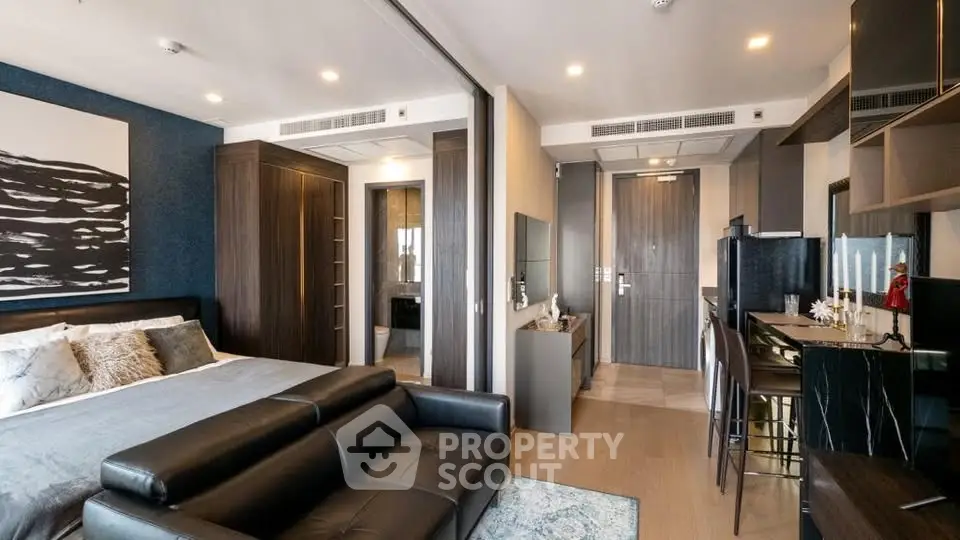 Modern studio apartment with open layout, featuring a cozy living area and stylish kitchen.