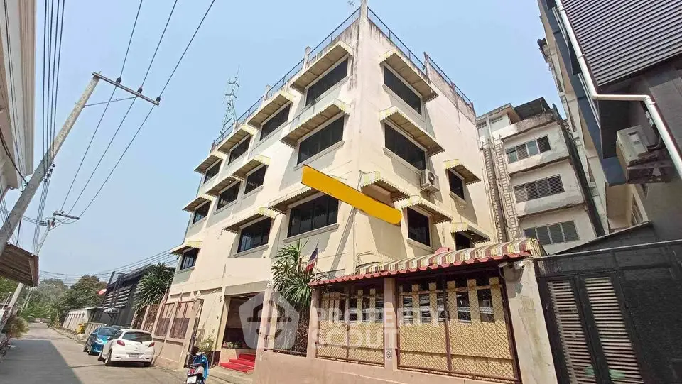 Charming multi-story building with unique architectural design in urban setting, ideal for investment.