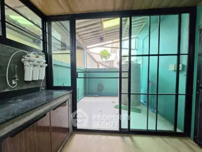 Modern utility area with water filtration system and outdoor access