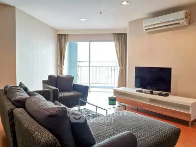 Spacious living room with modern furniture and balcony view in a stylish apartment.