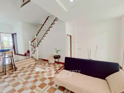 Spacious living room with modern staircase and stylish tile flooring