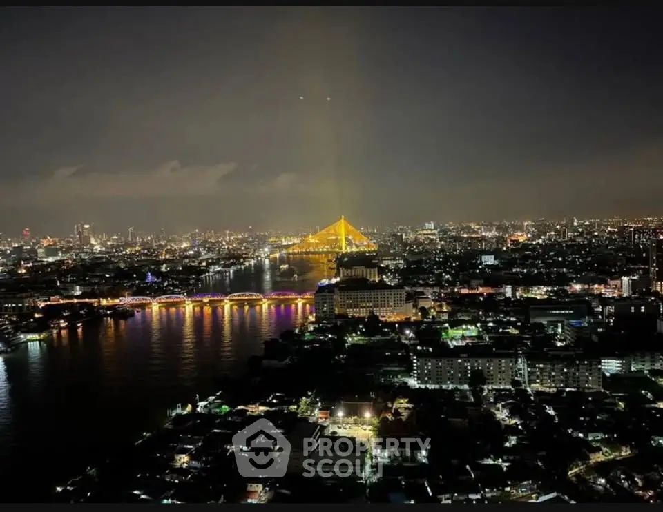 Stunning nighttime cityscape with illuminated bridge and river view, perfect for urban living enthusiasts.