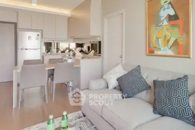 Modern living room with stylish decor and open kitchen layout in a contemporary apartment.