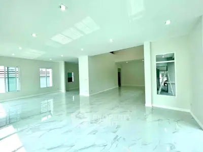 Spacious modern living room with glossy marble flooring and ample natural light.