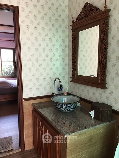 Charming bathroom with ornate mirror and stylish sink in cozy home