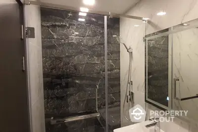 Luxurious bathroom with modern shower and elegant marble walls