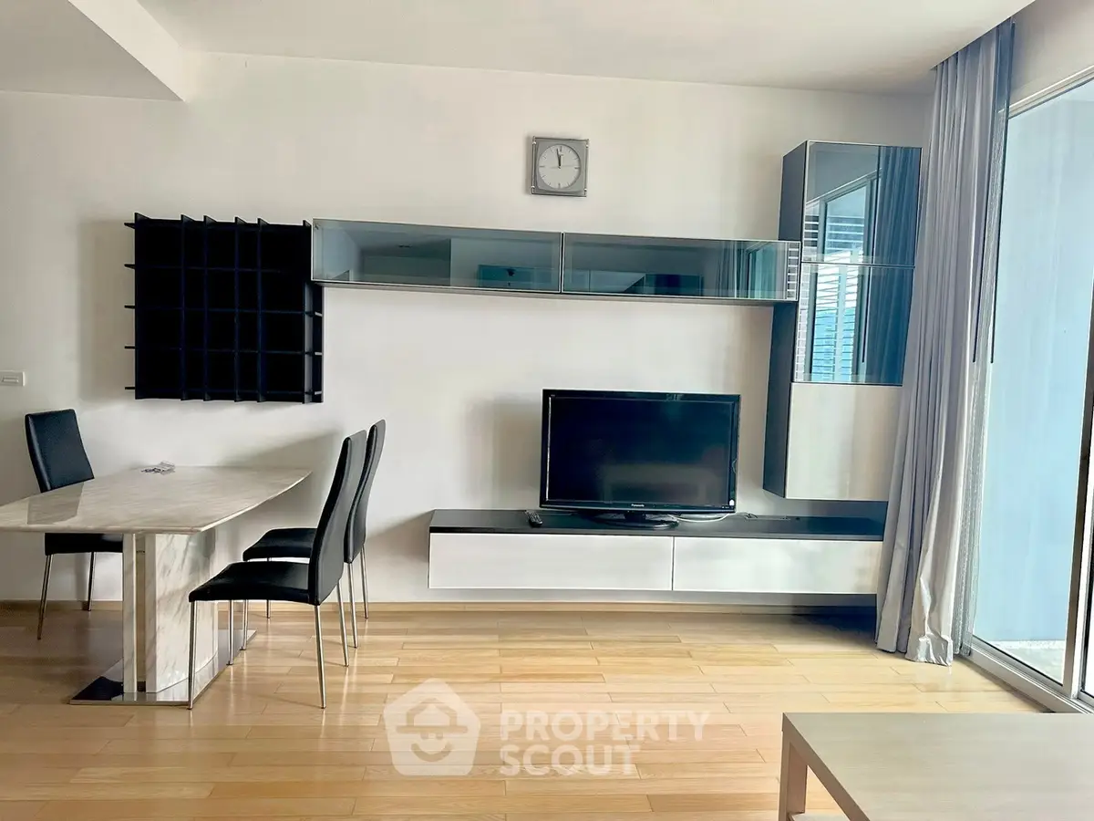 Modern living room with sleek furniture and large window for natural light.