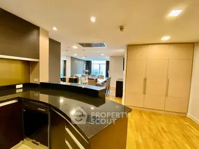Spacious open-plan kitchen and living area with modern design and wooden flooring.