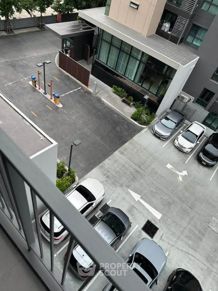 Modern apartment building with parking area and secure entrance, ideal for urban living.