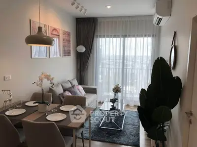 Modern living room with dining area, stylish decor, and large window offering natural light.