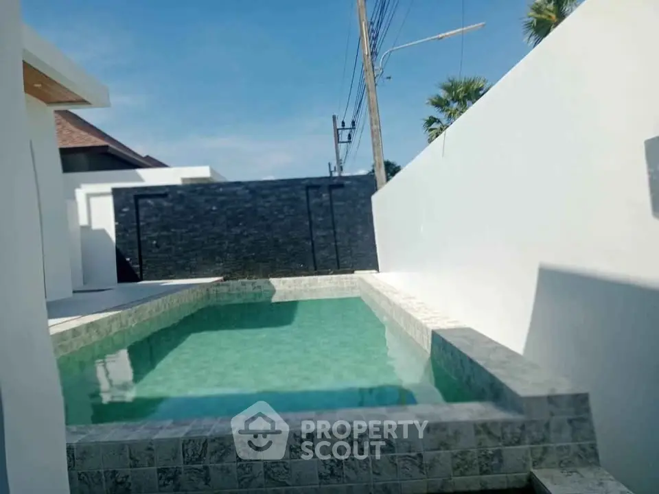 Luxurious private pool with modern stone design in a serene outdoor setting.