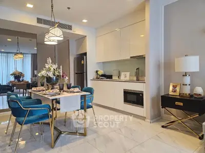 Modern open-layout kitchen and dining area with elegant decor and stylish furniture.