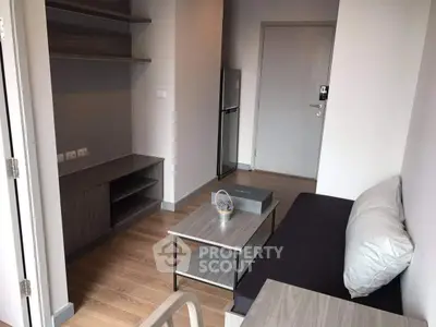 Modern living room with sleek furniture and wooden flooring in a cozy apartment.