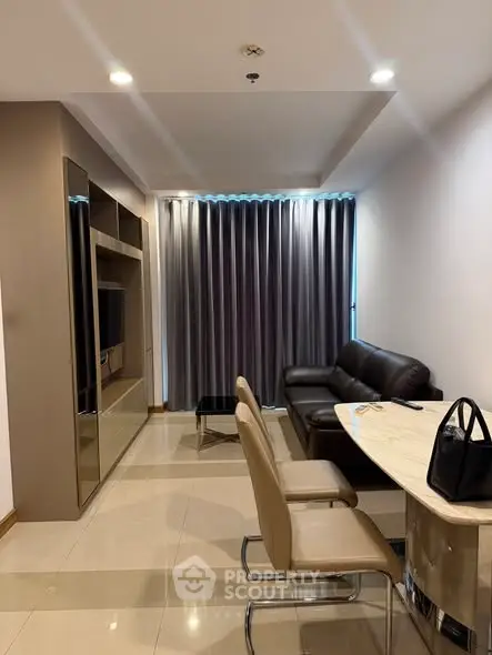 Modern living room with sleek furniture and elegant curtains in a stylish apartment.