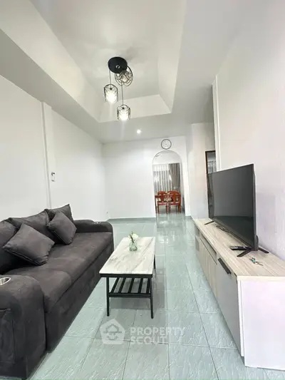 Spacious living room with modern decor and sleek furniture, perfect for relaxation and entertainment.