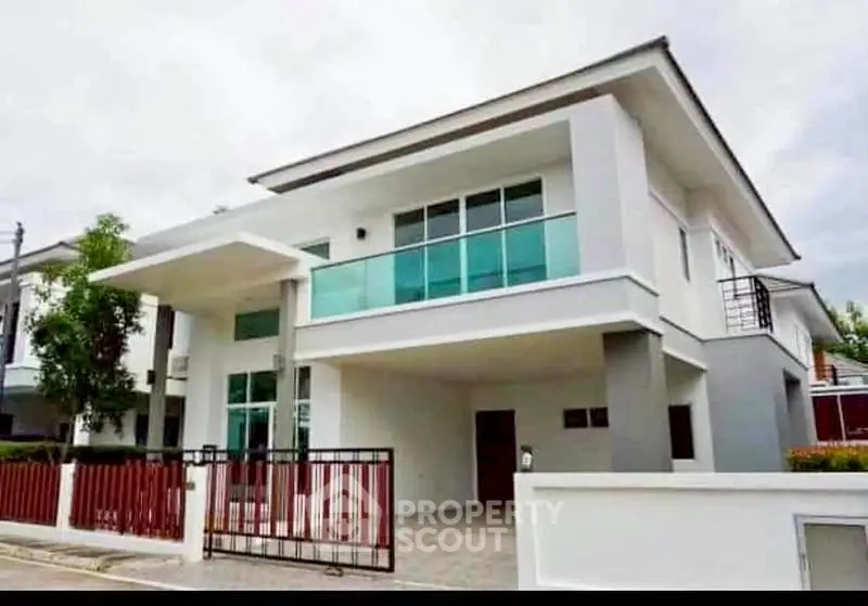 Modern two-story house with sleek design and large windows, perfect for contemporary living.