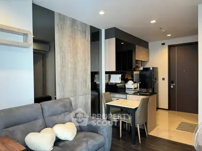Modern living room with cozy sofa and stylish kitchen in open layout apartment.