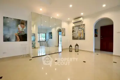 Spacious modern living room with elegant decor and large mirrors