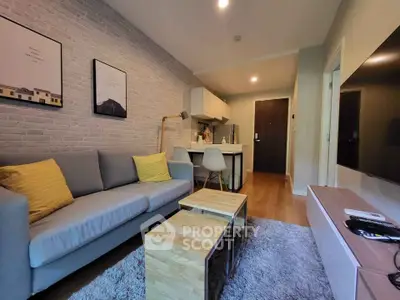 Modern living room with cozy sofa, stylish decor, and open kitchen layout in a chic apartment.
