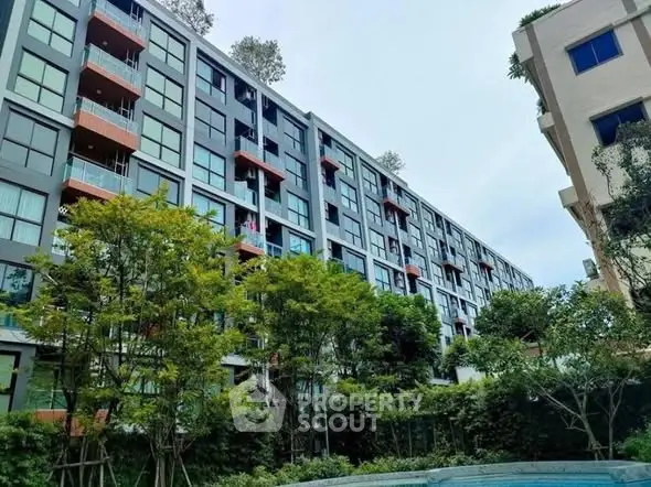 Modern apartment building with lush greenery and spacious balconies, ideal for urban living.