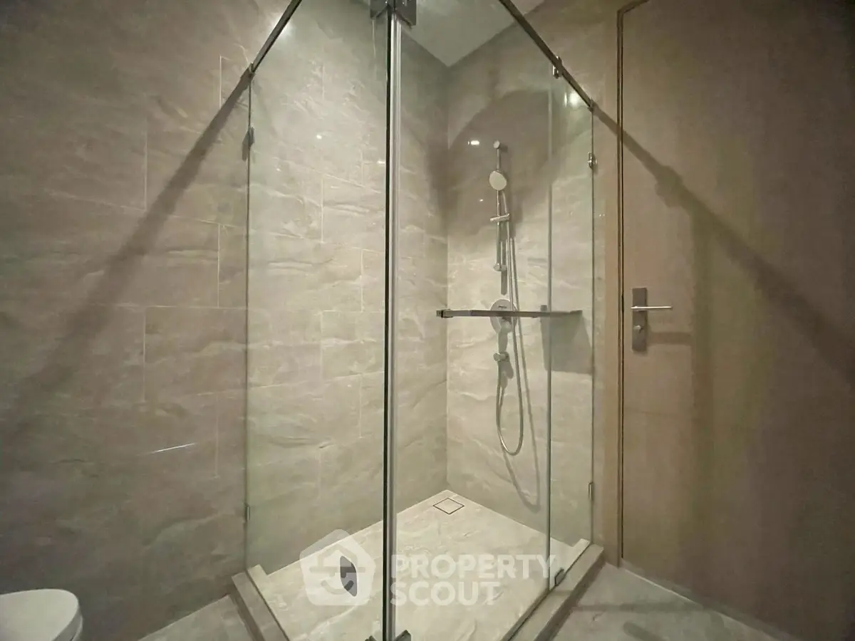 Modern bathroom with glass shower enclosure and sleek fixtures