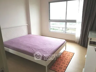 Bright bedroom with large window and minimalist decor