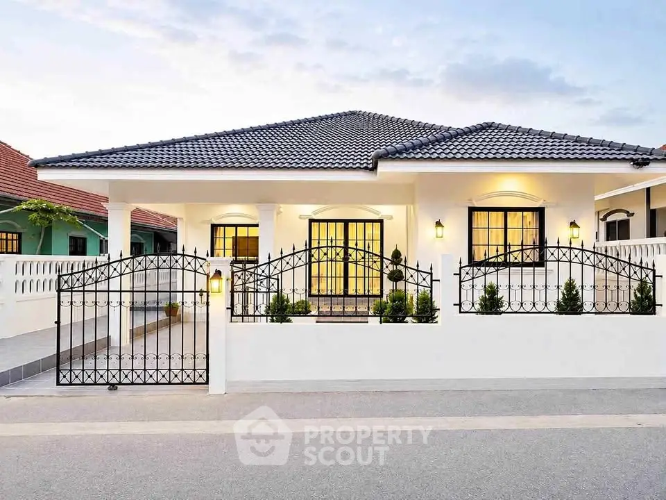 Charming single-story house with elegant wrought iron fence and well-maintained garden, perfect for family living.