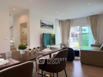 Modern living room with elegant decor and garden view, featuring a spacious layout and stylish furniture.