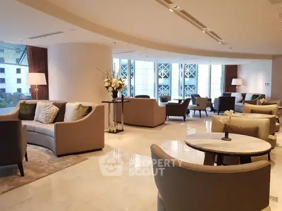 Luxurious modern living room with elegant seating and large windows.