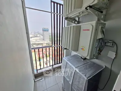 High-rise apartment balcony with city view and air conditioning units.