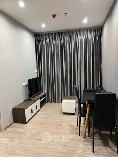 Modern living room with sleek furniture and elegant curtains in a cozy apartment.