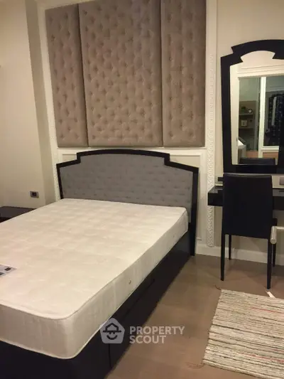 Elegant bedroom with stylish headboard and vanity mirror, perfect for modern living.