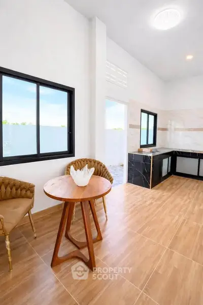 Modern kitchen with open layout and stylish dining area in a bright, airy space.