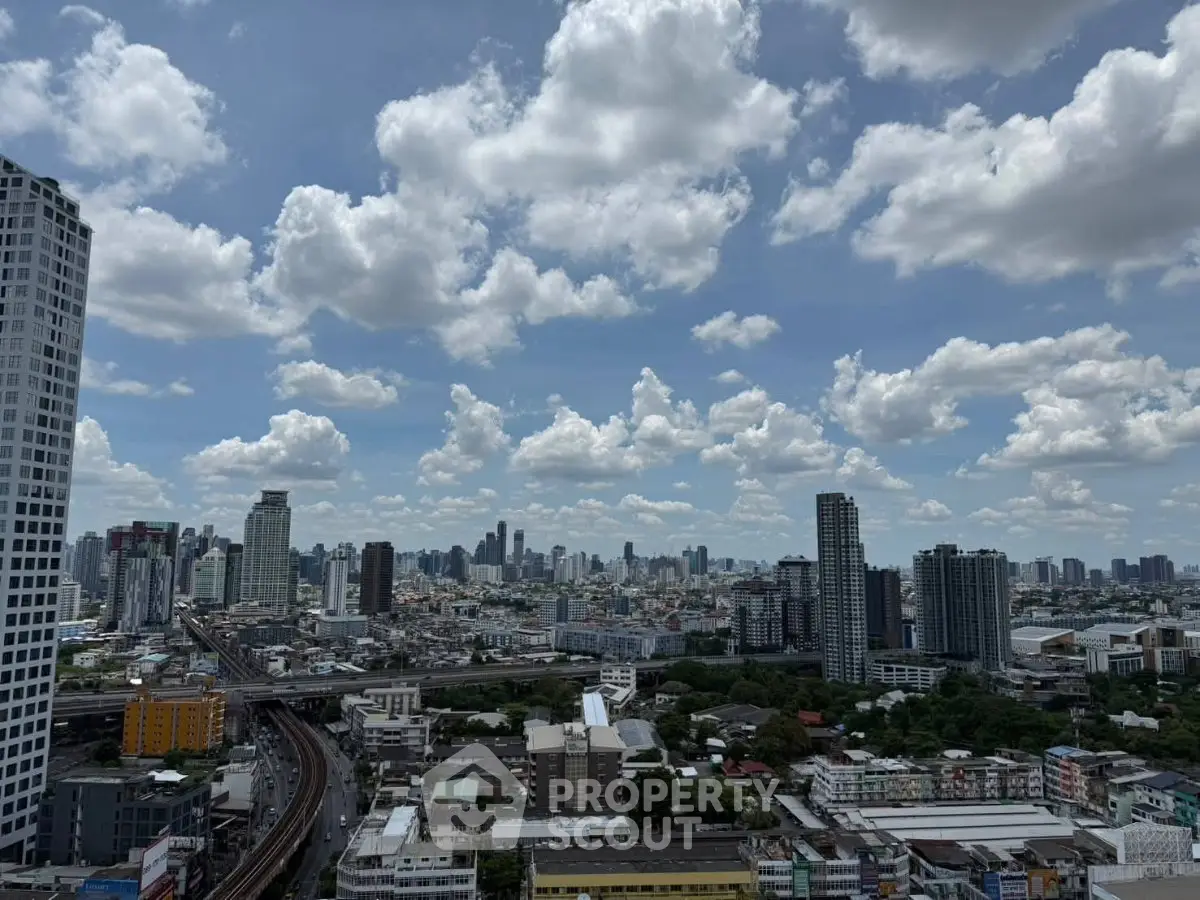 Stunning cityscape view from a high-rise building, showcasing urban skyline and vibrant clouds.