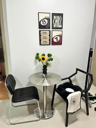 Stylish small dining area with modern chairs and decorative wall art