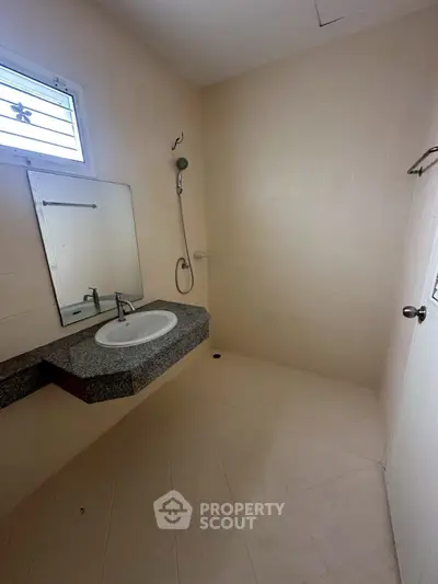 Spacious minimalist bathroom with modern fixtures and sleek design