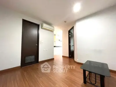 Spacious living room with wooden flooring and modern air conditioning unit