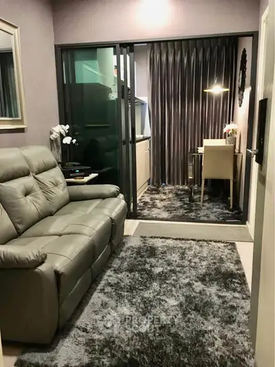 Modern living room with plush sofa and cozy study area, perfect for urban living.