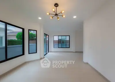 Spacious modern living room with large windows and stylish lighting