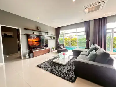 Spacious modern living room with pool view and stylish decor