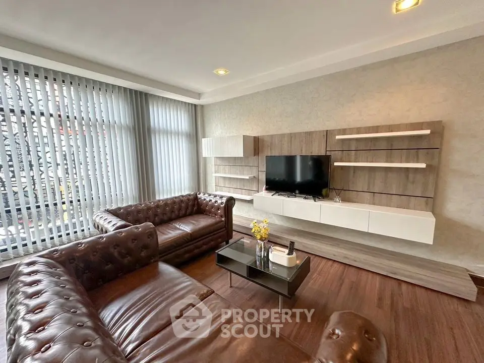 Luxurious living room with leather sofas and modern entertainment unit