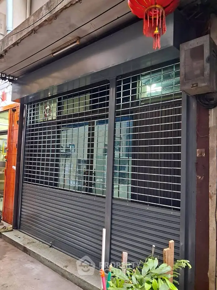 Secure commercial storefront with metal shutters in urban setting
