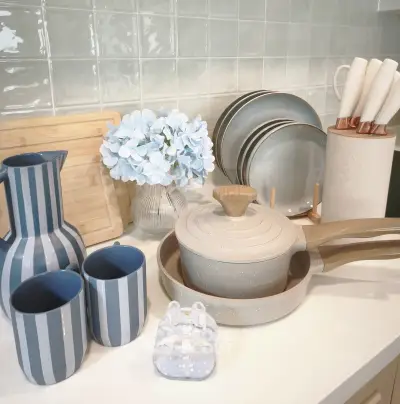 Stylish kitchen setup with modern cookware and elegant decor on a sleek countertop.