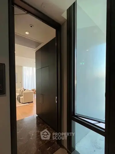 Luxurious apartment entrance with elegant marble flooring and modern interior design.