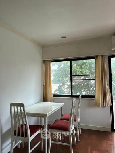 Cozy dining area with natural light and elegant white furniture.