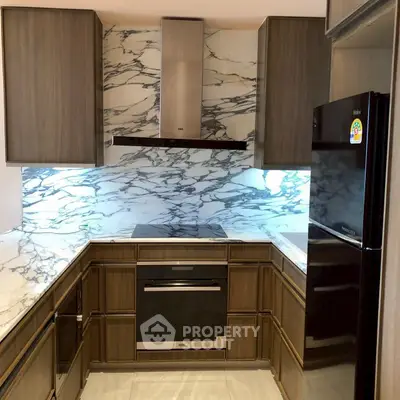 Modern kitchen with marble backsplash and sleek appliances.