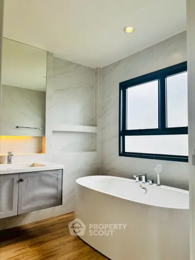Modern bathroom with elegant freestanding bathtub and sleek vanity